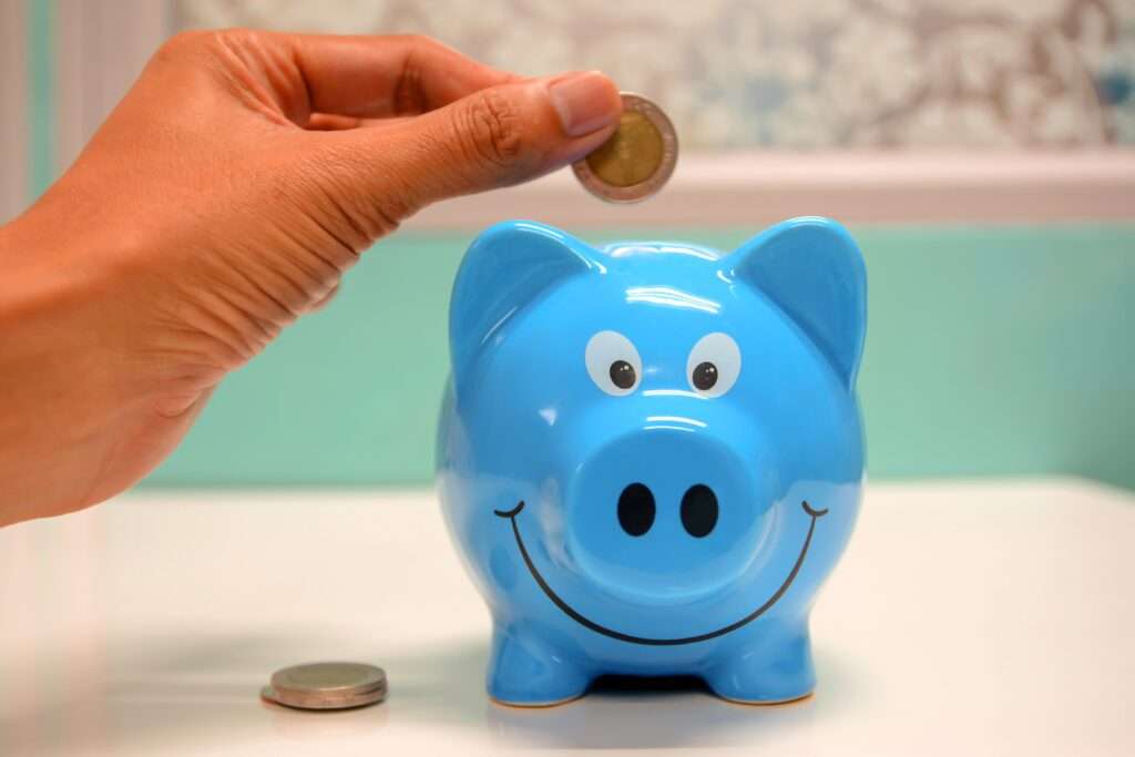 A coin is placed in a Piggy bank
