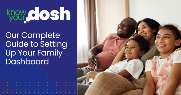 happy family sat together on sofa watching the television
