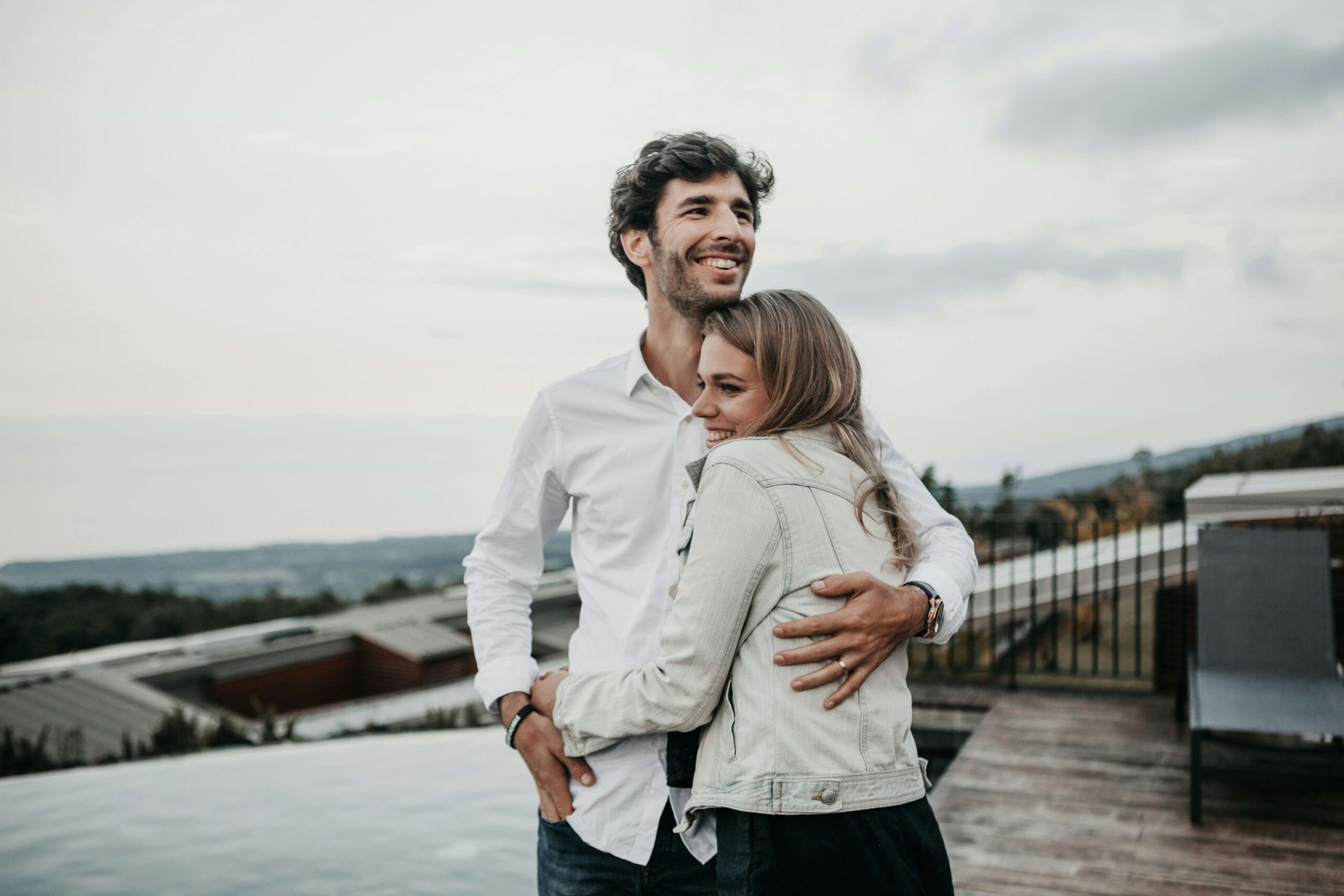happy couple hugging by the coast